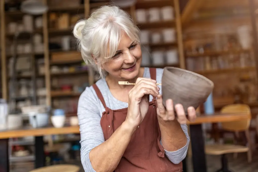 woman doing a unique hobby (pottery)